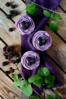 Blackberry cupcakes on a wooden table