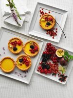 Tartlets with berries on a square plate