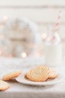 Simple homemade vanilla biscuits with a bottle of milk in the background