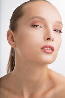 A young woman with rosé tinted make-up