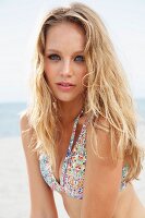 A young blonde woman wearing a patterned bikini top