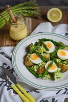 Asparagus salad with potatoes, broccoli, hard-boiled eggs and sauce Hollandaise