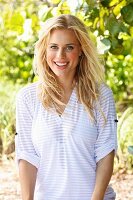 A young blonde woman wearing a transparent striped top