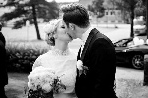 A bride and groom kissing (black-and-white shot)