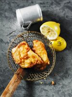 Fried halibut on a draining spoon