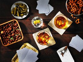 Guys night: playing cards, drinks and snacks on a table (seen from above)