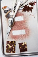 Prints from ice cream desserts on a baking tray with chocolate cake and cutlery