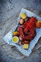 Cooked lobster with corn cobs and potatoes