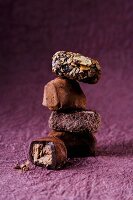 A stack of pralines on a purple surface