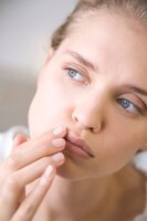 Woman applying lip balm