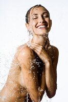 Topless woman under running shower