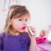 A little girl with smeared lipstick