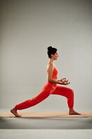 Sun Salutation – Step 4: take a step back and touch your index fingers to your thumbs