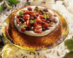 Berry cake with cream and peppermint leaves