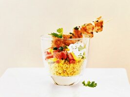 Chicken kebabs on a couscous salad served in a glass