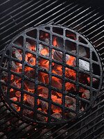 Glowing charcoal and a cooking grid