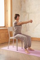 Woodcutter (yoga) – Step 1: sitting, arms forward, fingers interlocked