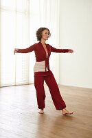 Opening wings (qigong) – Step 1: bow stance to the left, weight on right foot, raise arms to the side