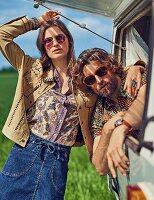 A hippie-style couple in a caravan