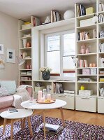 A natural white, made-to-measure shelf built around a window in a feminine room