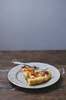 A slice of tomato quiche on a plate