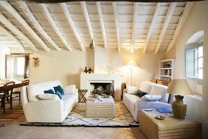 Open fireplace in bright, comfortable lounge area of restored, Mediterranean-style period building