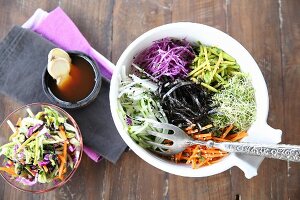 Vegan buddha bowl with different raw vegetables
