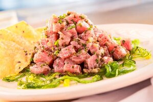 Tuna tartare with seaweed, ginger sauce and sesame seed chips