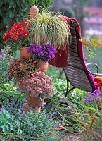 Tower of terracotta pots with Carex hachijoensis 'Evergold'