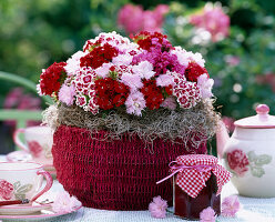 Basket with a Dianthus caesius (carnation, Dianthus) arrangement