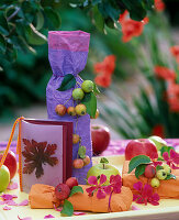 Small presents decorated with Malus (ornamental apples) and apples