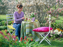 Woman drinking coffee in the garden