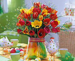 Tulip bouquet in vase with feathers