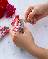 Wrapped glass tubes as vases on tablecloth (2/3)