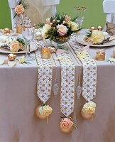 Table decoration with Dianthus (carnations), Pinus (pine), Rosa (roses)