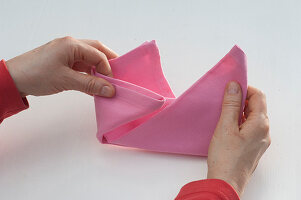 Napkins folding as a bishop's cap