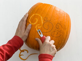 Carved pumpkin as a candleholder and as a vase