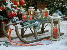 Angel bust on tray of metal, lanterns, lanterns on sledges