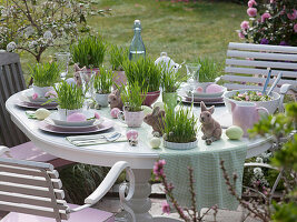 Easter table with Easter grass in cups and pots