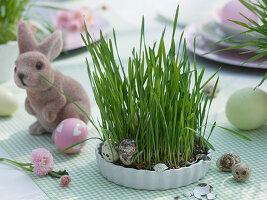 Easter table with Easter grass in cups and pots
