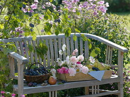 Freshly picked plums, pears and freshly cut flowers