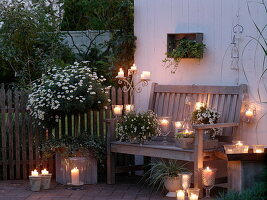 White evening terrace with lanterns and candles