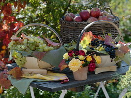 Table with grapes and apples in baskets