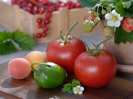 Still life with tomatoes, green peppers and apricots