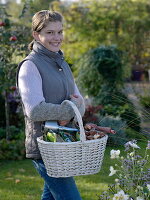 Young woman carrying wicker basket with bulbs and bulb setter