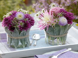 Glass vases wrapped with stachysheets, with autumn bouquets