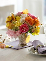 Autumn rose bouquet with clematis fruit and autumn leaves