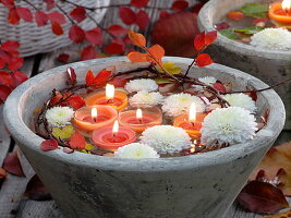 Schwimmkerzen und schwimmende Blüten von Chrysanthemum