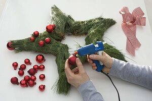 Star with red balls and pine needles