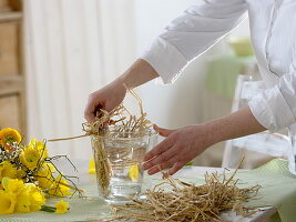 Yellow spring bouquet in straw vase